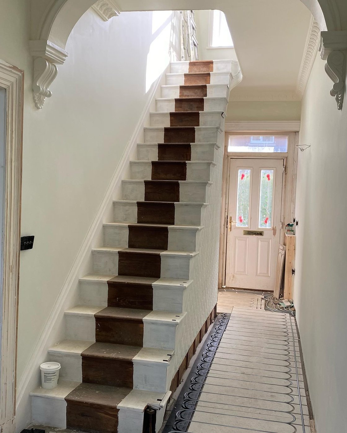 The landing and hall painted, banister stripped