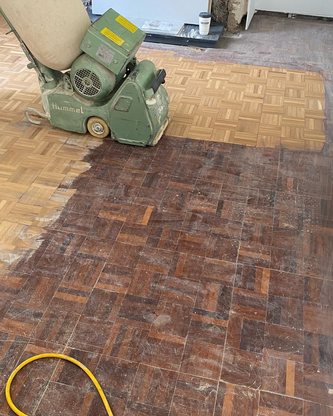 The original parquet floor being sanded back